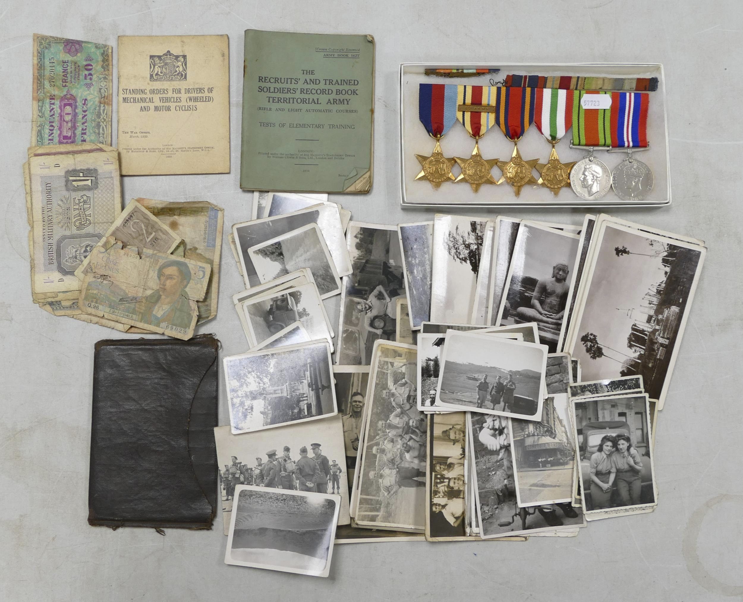 This collection of medals and items belonging to a soldier, including a group of medals such as an Africa Star with 8th Army bar, Italy star, 1939-1945 star, Burma star, Defense and Victory medal together with Army jacket & various Army books, currency and photographs from Burma, currency and more, sold for £220.