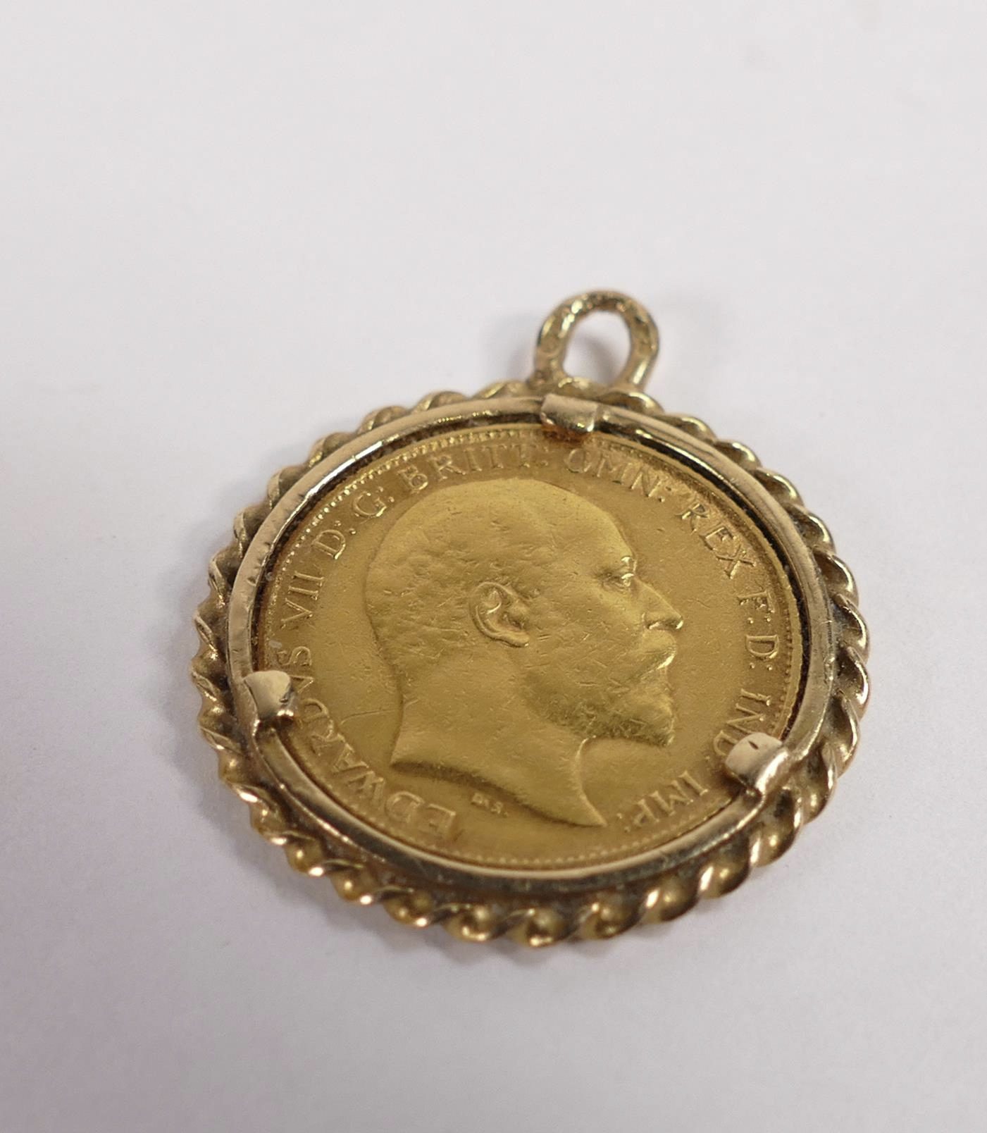 This gold half sovereign dated 1903 and mounted in 9ct gold mount sold for £220.